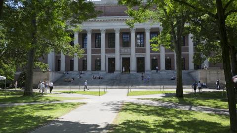The front of Harvard's Widener Library surrounded by trees