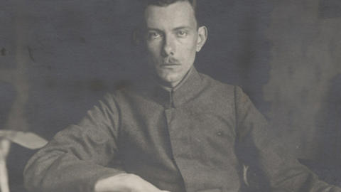 An early photograph of Paul Tillich seated at a table.