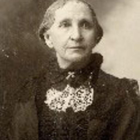 The Rev. Mary Billings sits for a portrait in a black dress and white lace collar.